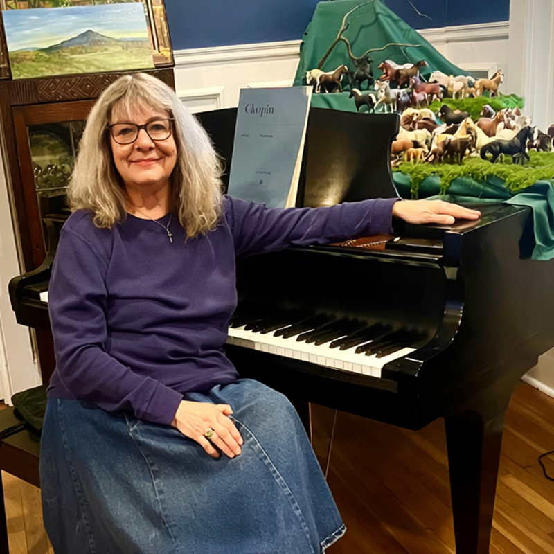 Karen Happ piano teacher in her studio at the grand piano
